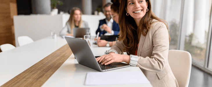 A group of employees smile while at an event